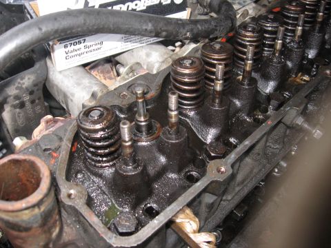 1981 Ford Bronco - Spring, keeper, and oil seal removed and the valve stem visible.