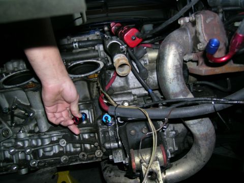 1995 Ford Probe - Close-up view of an engine with a turbocharger and various hoses and fittings attached.