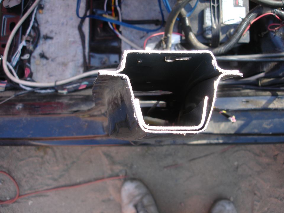 Cut metal frame with exposed wiring and engine components