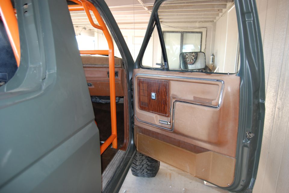 Interior door panel with wood trim and orange roll cage, 1982 Ford Bronco
