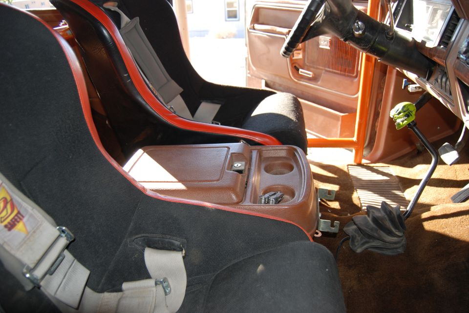 1982 Ford Bronco interior showing racing seats, center console with cup holders, and steering wheel
