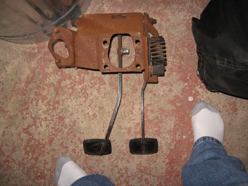 Rusty brake and clutch pedals with mounting bracket and spring