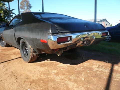 1975 Ford Ranchero - Rear view of a 1975 Ford Ranchero, showing its chrome bumper and taillights.