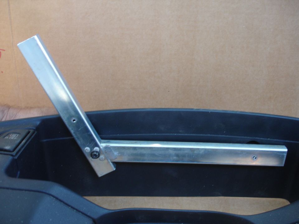 Custom aluminum camera mount attached to a black car interior console