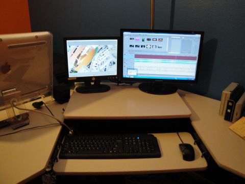 1993 Ford Taurus - Dual monitor computer setup on a desk, showing a timeline editing interface on the right screen.