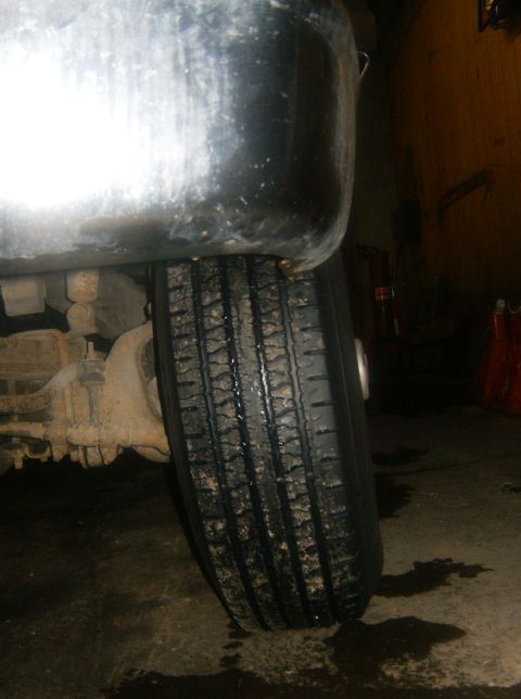 2000 Ford E350 - Close-up of a vehicle's tire and fender, showing wear and tear.