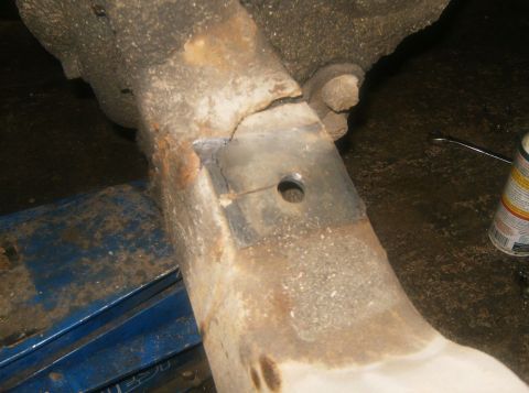 2000 Ford E350 - Close-up of a corroded vehicle frame showing a welded patch and a mounting hole.