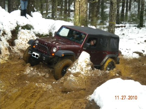 2005 Jeep Wrangler - Jeep Wrangler navigating difficult terrain with mud and snow.