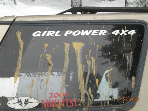 2005 Jeep Wrangler - Mud-splattered side window displays "GIRL POWER 4X4" and "2005 MUD FEST" stickers, with a date of 11.27.2010 visible.