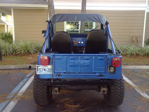 1978 Jeep CJ5 - Rear view of a blue 1978 Jeep CJ5, showing its tailgate with 'Jeep' embossed and a Florida license plate.