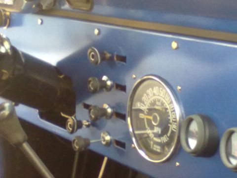 1978 Jeep CJ5 - Close-up of the blue dashboard in a 1978 Jeep CJ5, showing the speedometer and fuel gauge.
