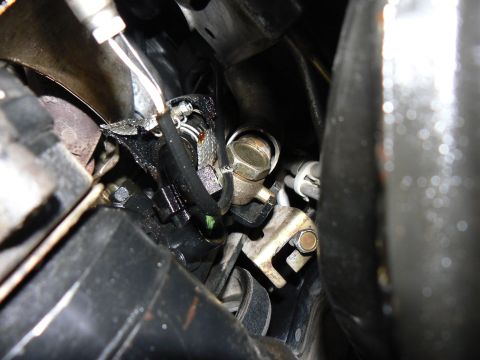 1978 Ford Bronco - A detailed view of engine components, showing various hoses, wires, and metal fittings.