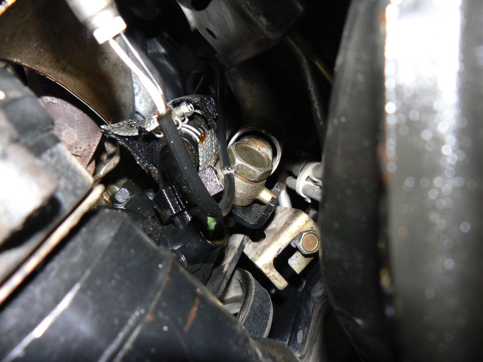 Close-up of engine parts, including hoses and metal brackets