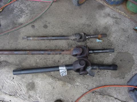 1992 Ford Bronco - Comparison of three drive shafts, likely for a vehicle repair or upgrade project.