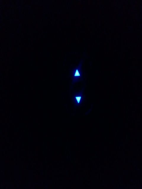 2003 Ford Crown Victoria - Illuminated arrow indicators on a dark background, possibly from a control panel.