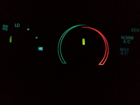2003 Ford Crown Victoria - Climate control panel with illuminated settings for fan speed and air conditioning modes.