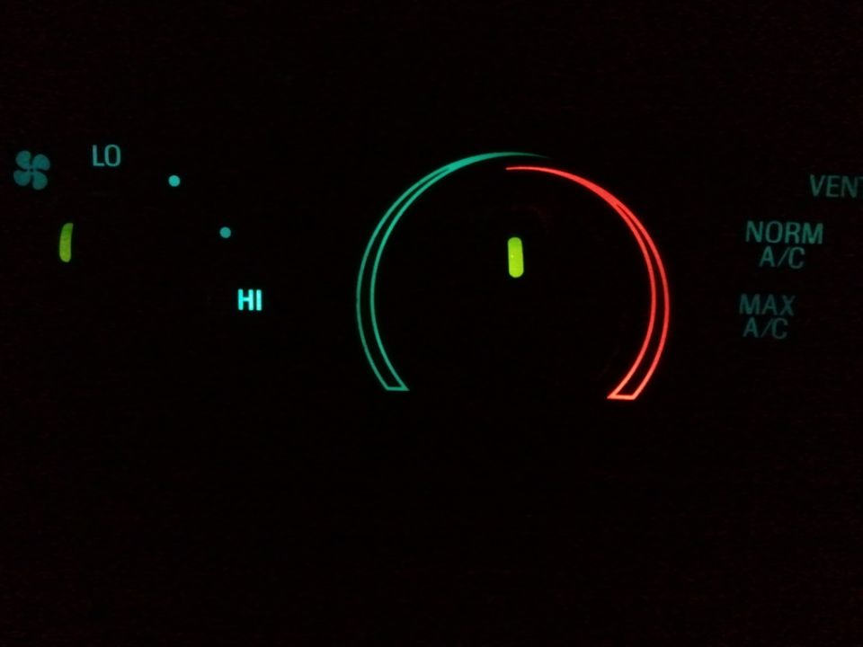 Car climate control panel with LO and HI settings, and a dial showing NORM A/C and MAX A/C