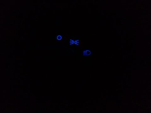2003 Ford Crown Victoria - Close-up of illuminated dashboard indicator lights in a dark environment.