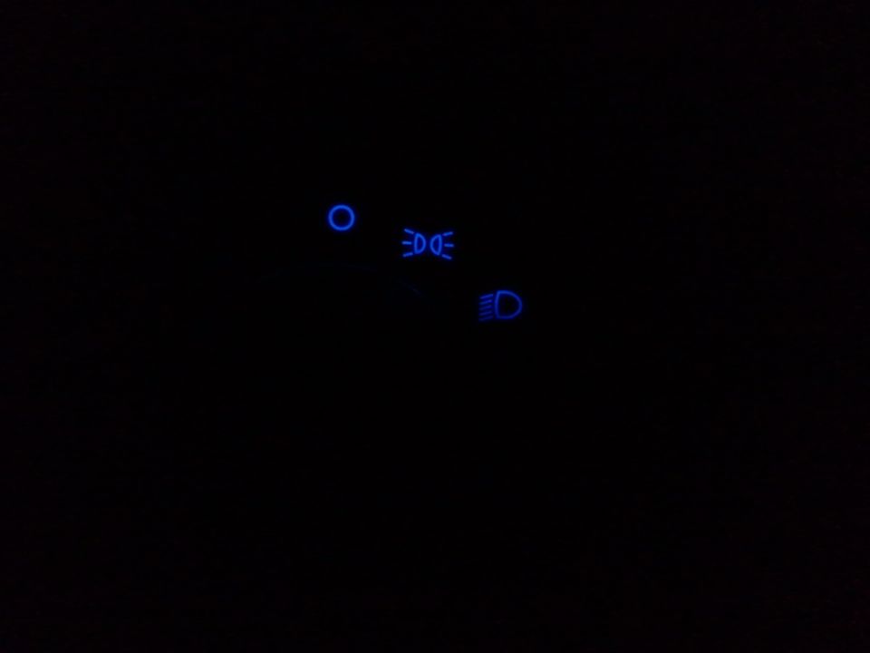 dashboard lights showing headlights, high beams, and a circular indicator
