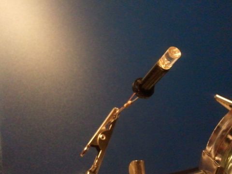 2003 Ford Crown Victoria - A close-up shows an LED light connected to wires and a clip, with the Supermotors logo in the corner.