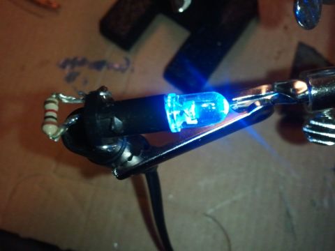 2003 Ford Crown Victoria - A close-up shows a blue LED light connected to a resistor and wires, likely for a vehicle's interior lighting modification.