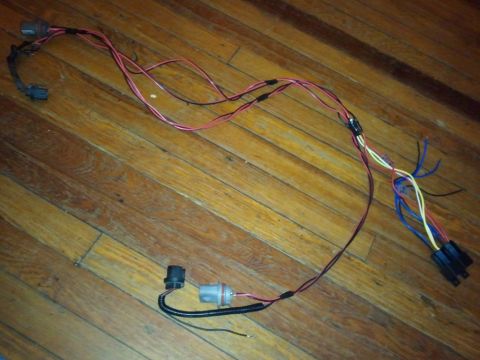 2003 Ford Crown Victoria - This is a vehicle wiring harness, likely for lighting components, shown on a wood-planked surface.