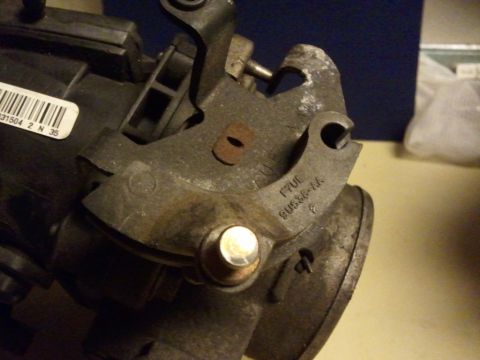 2003 Ford Crown Victoria - Close-up of a throttle body part, showing casting numbers F7UE 9U536-AA and a barcode label.
