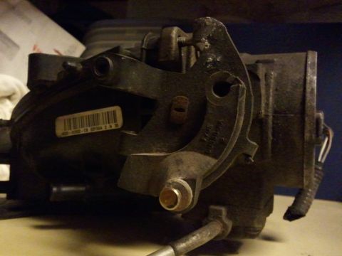 2003 Ford Crown Victoria - Close-up of a vehicle throttle body, showing a barcode sticker and electrical connections.