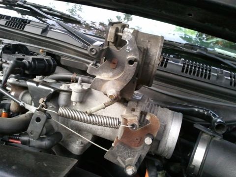 2003 Ford Crown Victoria - The throttle body assembly is shown in detail, with visible springs and linkages.