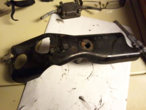 2003 Ford Crown Victoria - Close-up of a throttle body bracket, likely a replacement part for a vehicle.