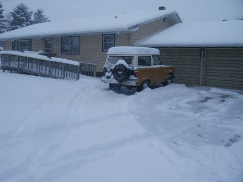 1966 Ford Bronco - A 1966 Ford Bronco is partially buried in snow during a winter storm.