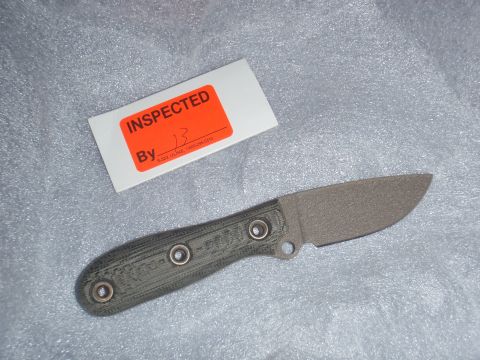 1991 Ford Bronco - A knife with a textured handle and a gray blade is shown next to an inspection sticker.