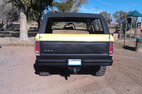 1979 Ford Bronco - This Ford Bronco is parked outdoors near a playground on a sunny day.