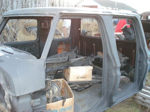1977 Ford F-150 - The interior of a 1977 Ford F-150 cab is shown, filled with various parts and components.