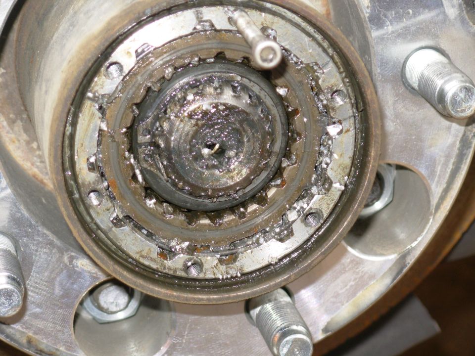Close-up of a greasy splined hub and bearing assembly