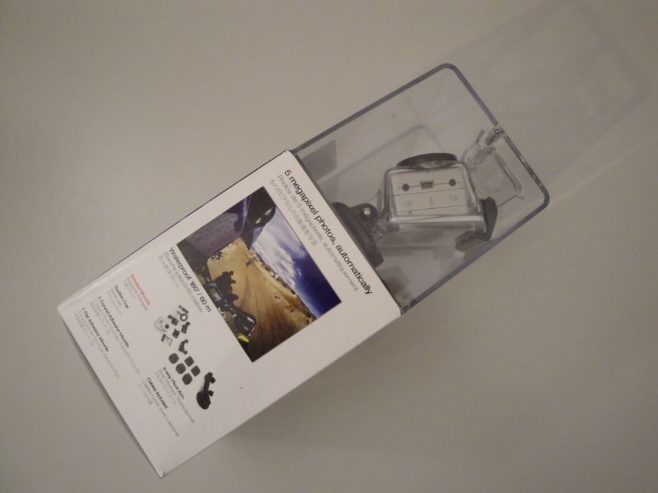 Camera in clear plastic packaging with product information on the side
