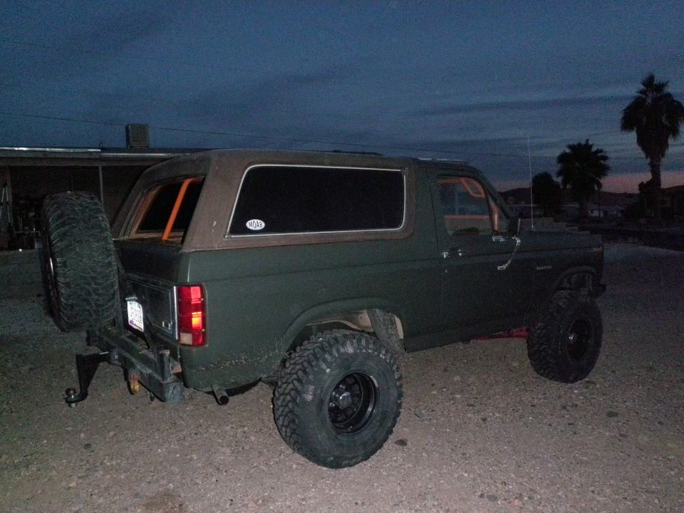 Green 1982 Ford Bronco with spare tire mounted on rear bumper