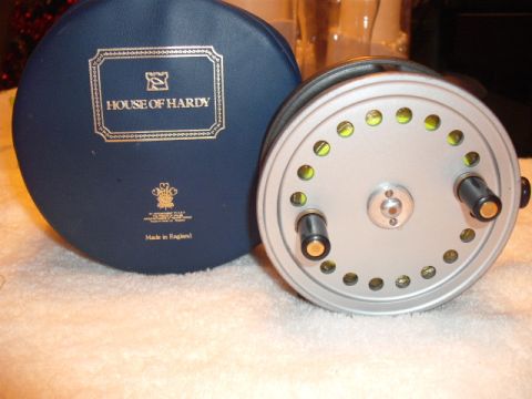 1990 Ford Bronco - Fishing reel and its case are shown. The case has 'HOUSE OF HARDY' printed on it.