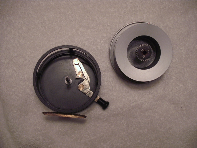 disassembled fishing reel with handle and gears