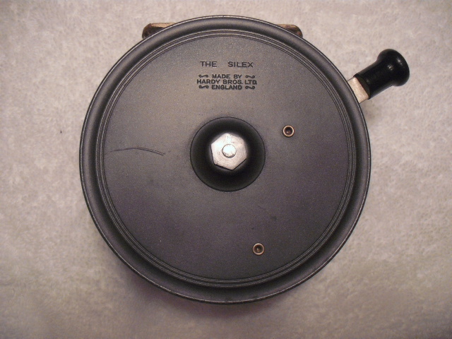 Fishing reel with black handle, "The Silex" text, and "Made by Hardy Bros. Ltd England" text