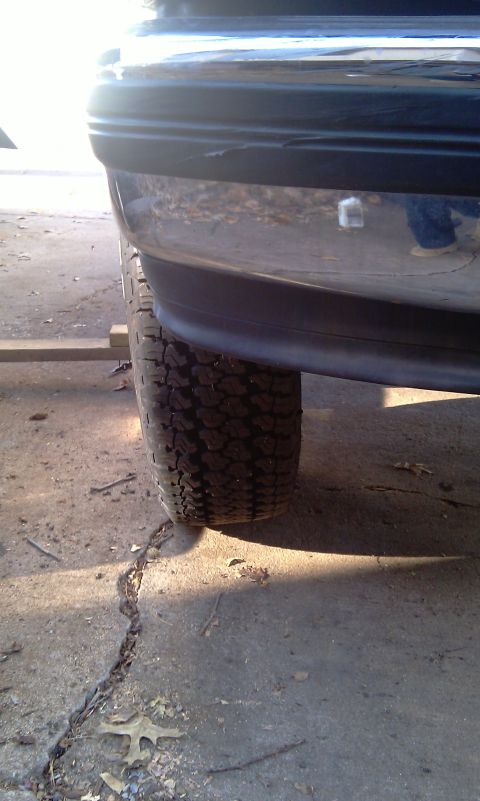 1993 Ford Bronco - Close-up view of the rear bumper and tire of a 1993 Ford Bronco.