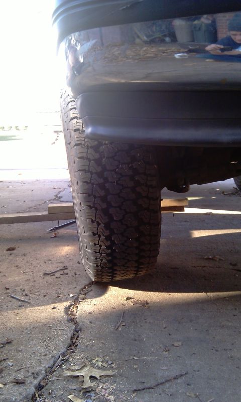 1993 Ford Bronco - Rear tire and bumper detail of an unidentified vehicle.