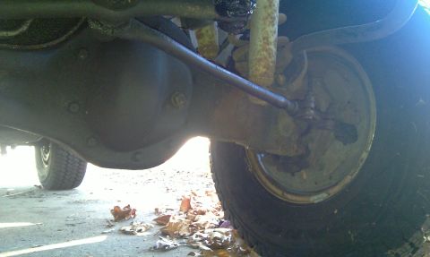 1993 Ford Bronco - Undercarriage view showing the rear axle assembly and suspension parts of a vehicle.