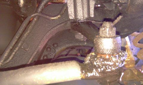 1993 Ford Bronco - Undercarriage view of a vehicle's suspension system, showing a ball joint and associated components.