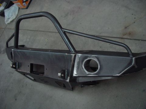 1993 Ford Bronco - A custom steel bumper with a brush guard is shown from the front, a winch cutout and tow hooks.