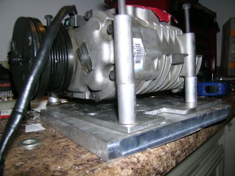 1995 Ford Probe - Close-up of a supercharger assembly, likely for a custom build, resting on a workbench surface.