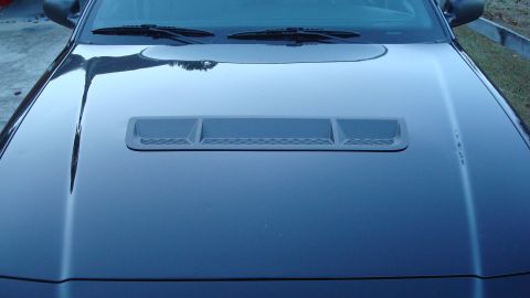 2004 Ford Crown Victoria - Hood scoop detail on a dark-colored vehicle.