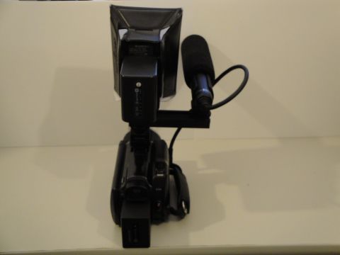 1993 Ford Taurus - A video camera is equipped with a directional microphone and a light for recording.