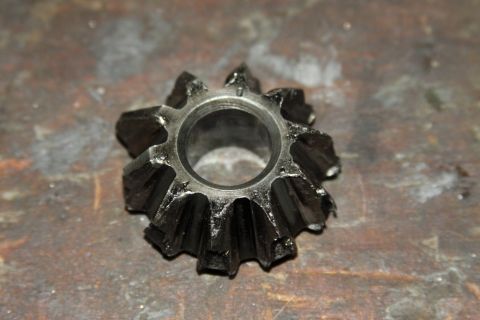 2004 Jeep TJ - A close-up view of a damaged spider gear, likely from a differential, showing significant wear and broken teeth.