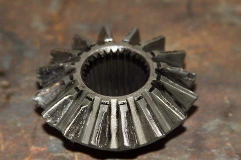 2004 Jeep TJ - A differential spider gear shows significant wear and damage to its teeth.